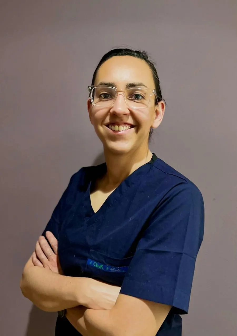 Dana Whitfield, dental hygienist, smiling in navy scrubs