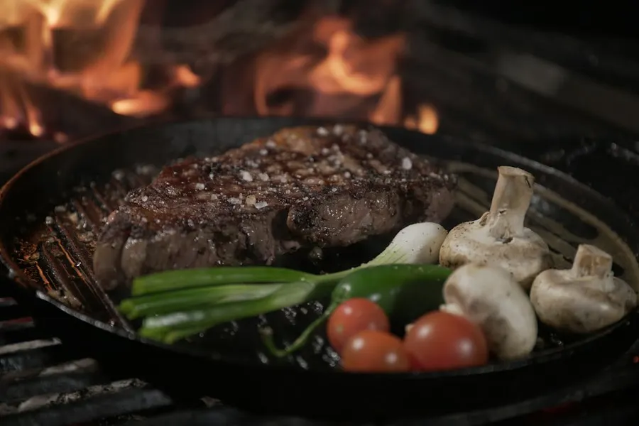 Steak and mushrooms in a cast-iron pan over the fire
