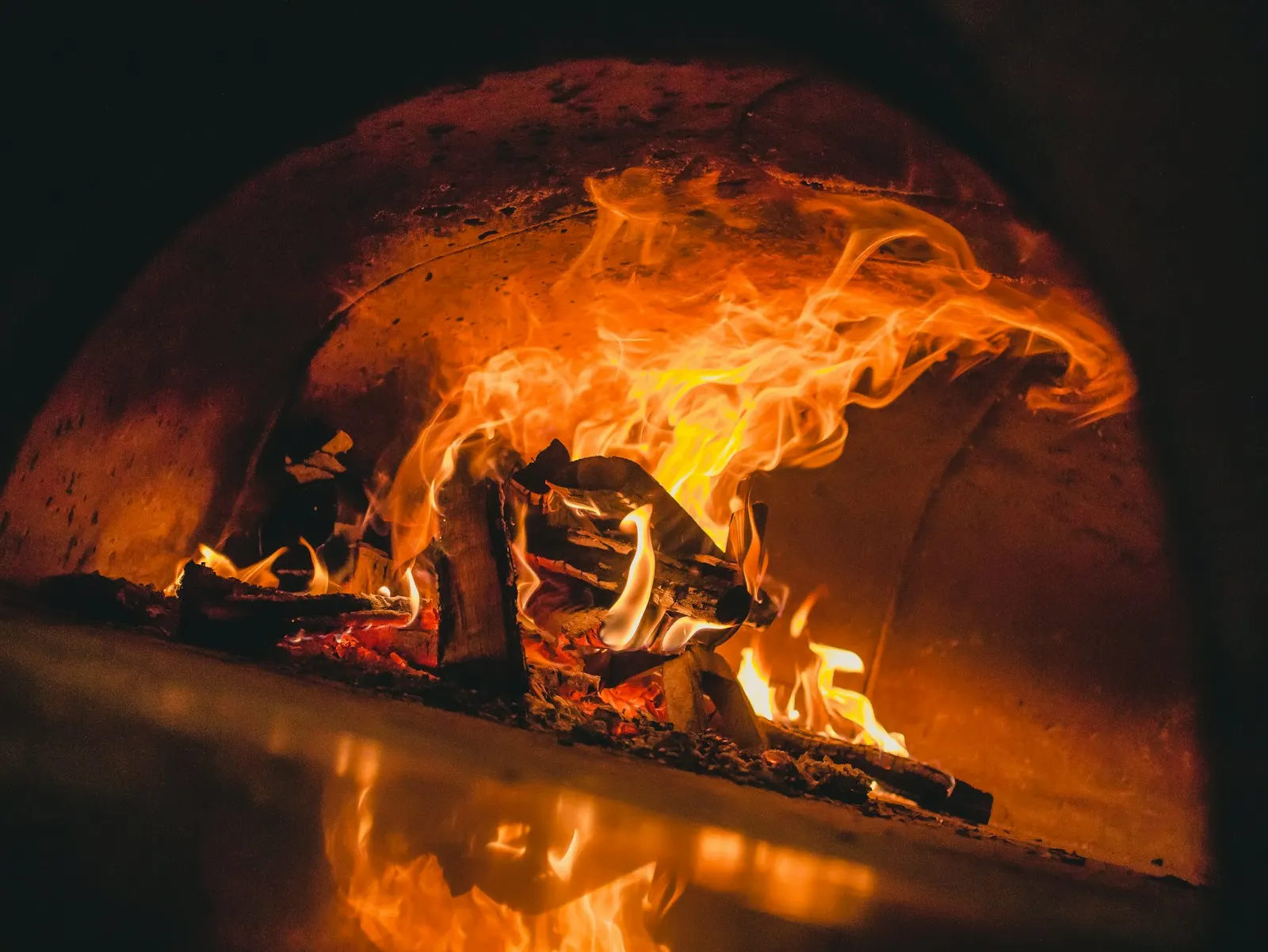 Flames rolling across the ceiling of the brick hearth oven