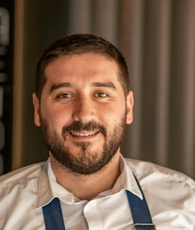 Mateo Alvarez, smiling, in a white shirt
