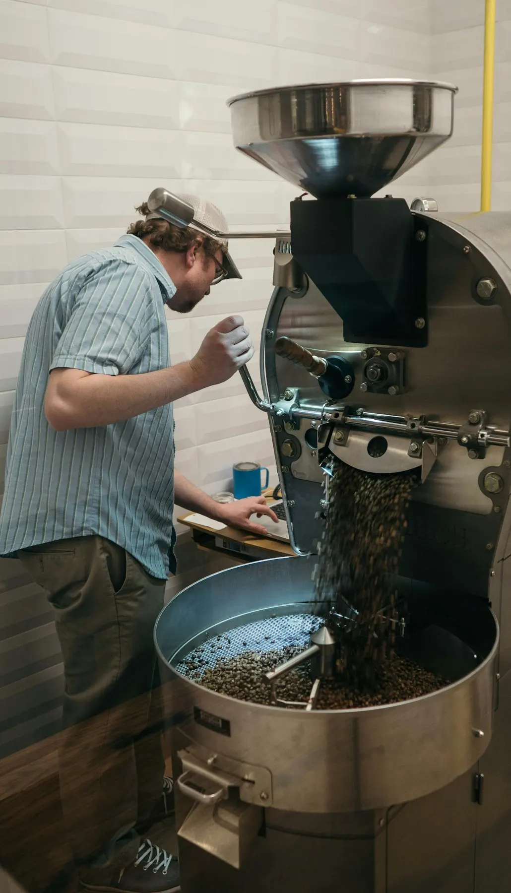 A roaster releasing a finished batch into the cooling tray