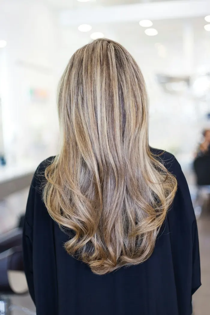 Long blonde balayage with a darker root