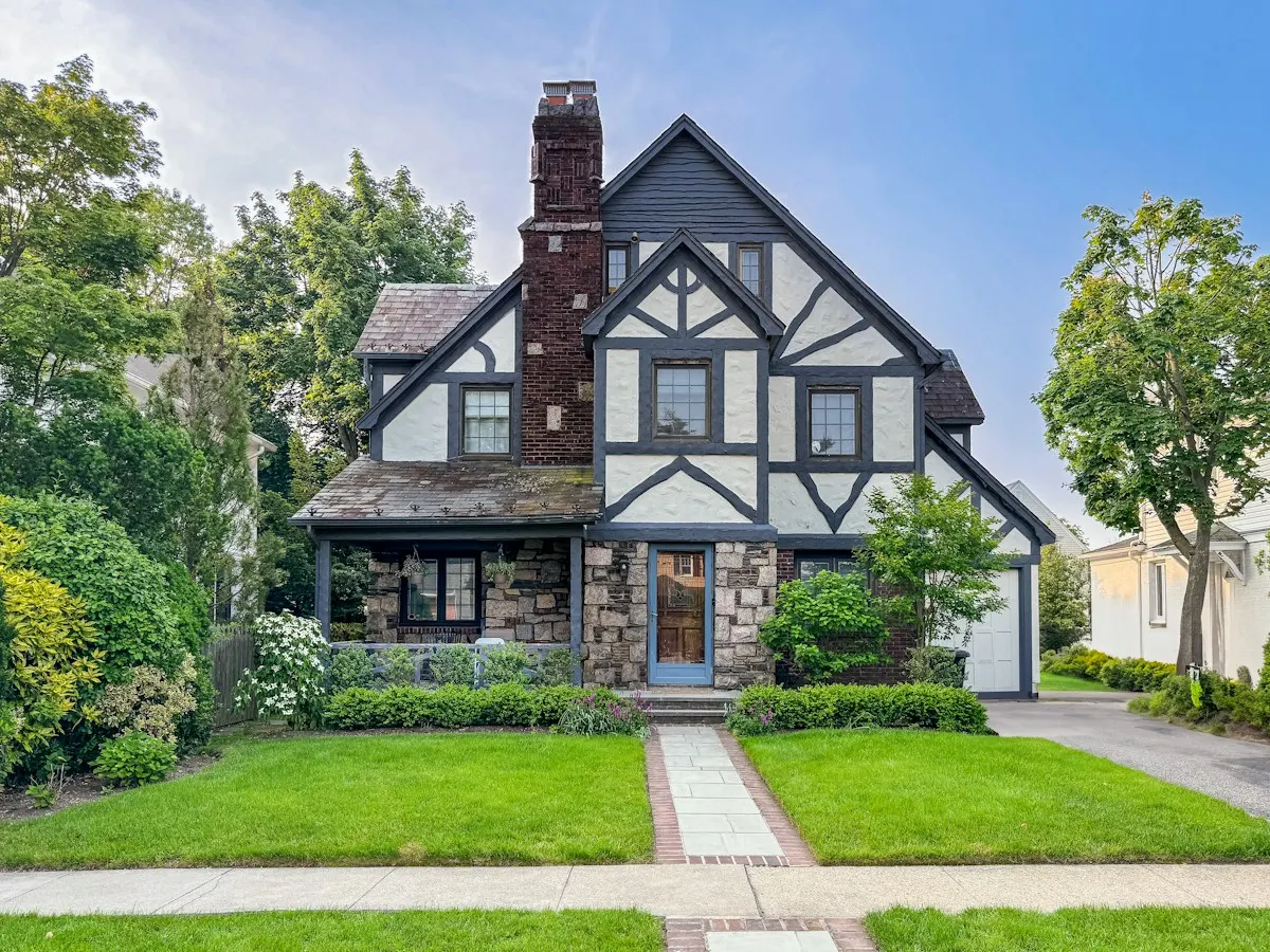 Tudor revival house with a steep new roof and rebuilt brick chimney
